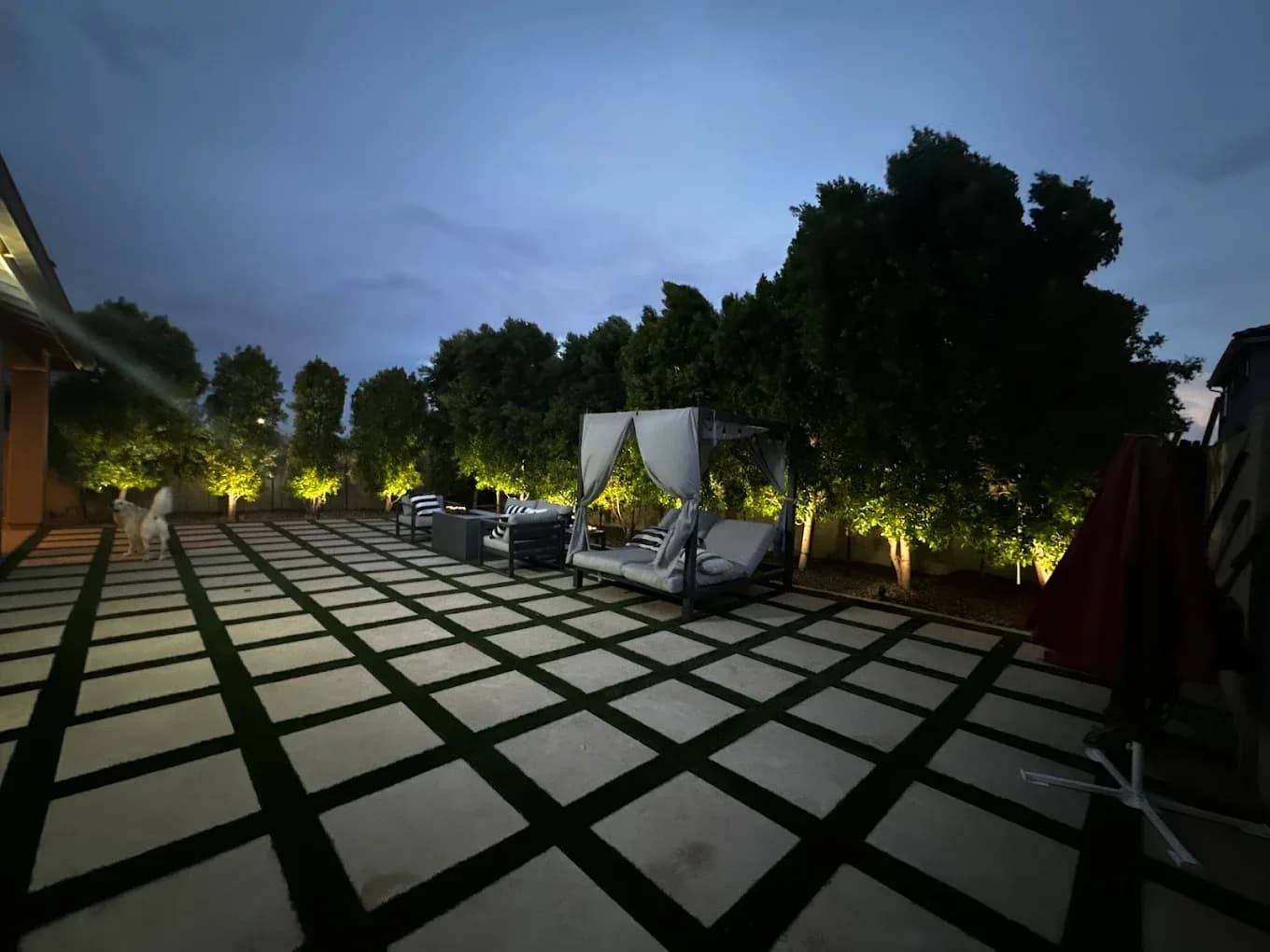 Paver-grid patio with landscape lighting